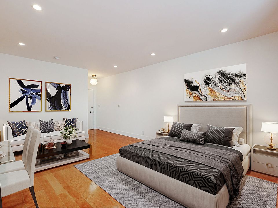 STAGED MAIN ROOM: QUEEN BED, SOFA, COFFEE TABLE & DESK AREA