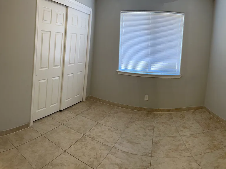 Bedroom 2 with view of hallway and Bedroom 1 at the end.