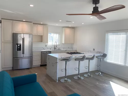 Newly remodeled open concept kitchen with new cabinets, $4200 KitchenAide fridge, $1200 Kitchenaide dishwasher, huge 9' marble peninsula with $4500 chef's stove and barstool seating. - 4673 Terrace Dr #B