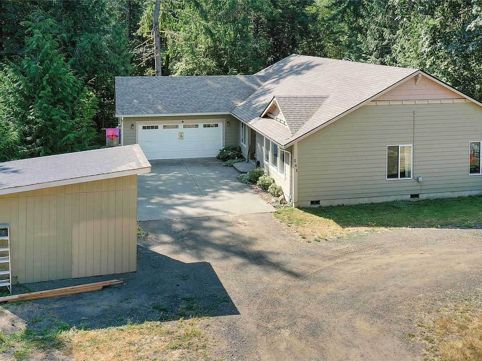 Drone shot of front of home, brand new shed and circle drive. Property is nicely wooded but not right around the home. >