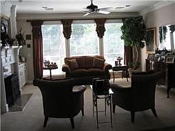 Lovely formal living has great views to the backyard pool area 