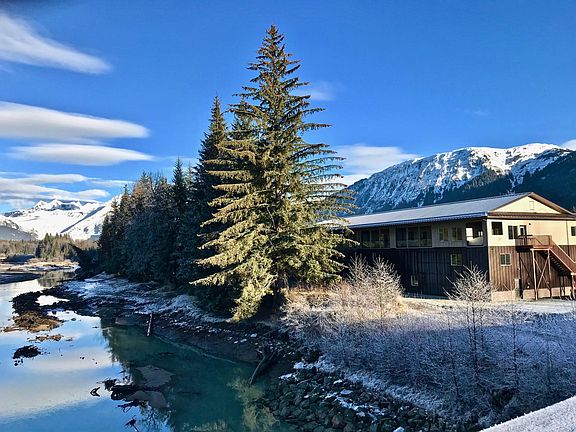 View of condo building B from Brotherhood Bridge over Mendenhall River with Mendenhall glacier in background