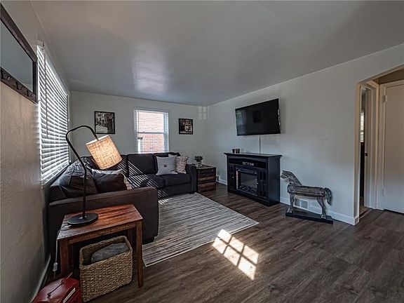 This cozy family room is well lit and perfect for family and friends to enjoy.