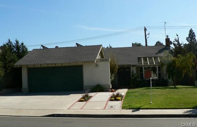 Nice drive up appeal with mature landscaping. Extra width to th