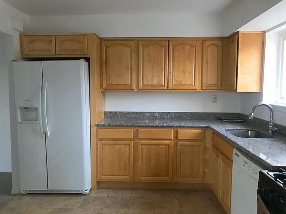 Large kitchen with refrigerator, stove, and dish washer