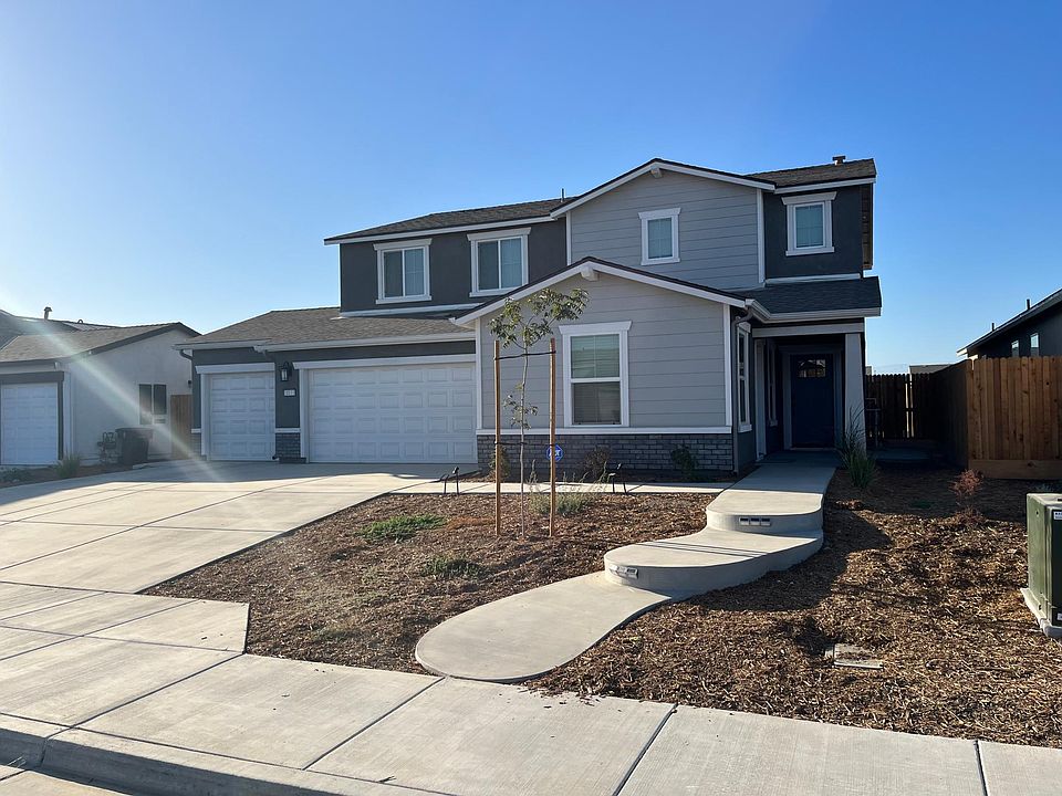 Front view with concrete steps and paved large driveway for three cars
