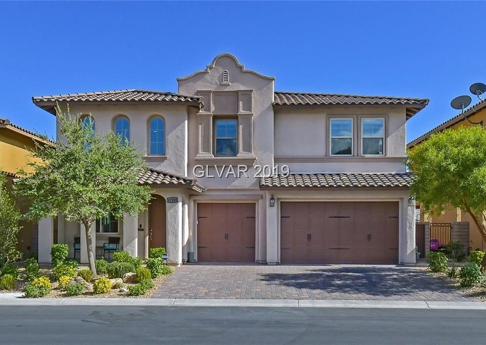 Pavered driveway with a 3 car garage and storage. Small accent front porch