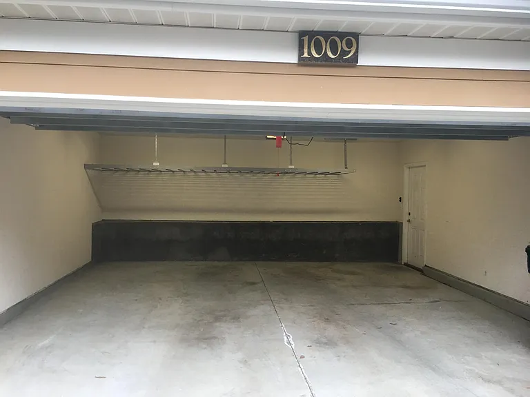 Double garage with storage rack and side door.