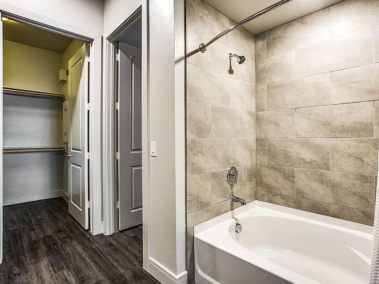 Luxury bathrooms featuring modern fixtures, and soaking tubs with tile tub surrounds