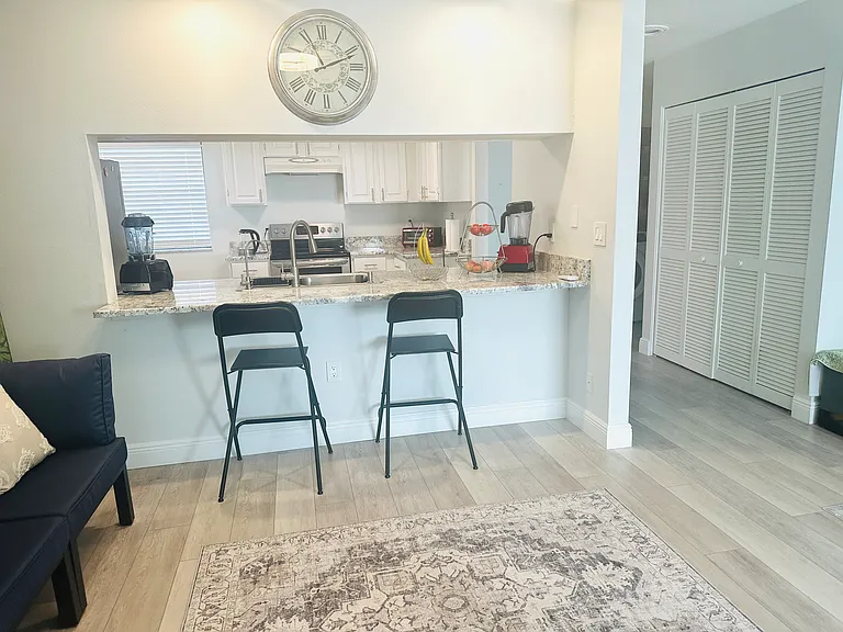 View of kitchen from living room/dining room/great room area.