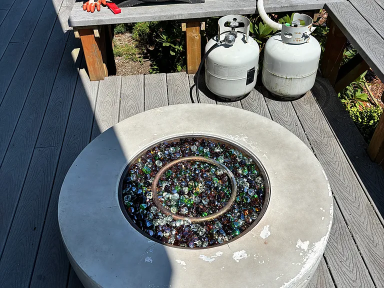 Gas firepit and grill on front deck.