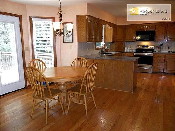 Spacious eating area, hardwood floors. Enclosed blinds on door to deck.