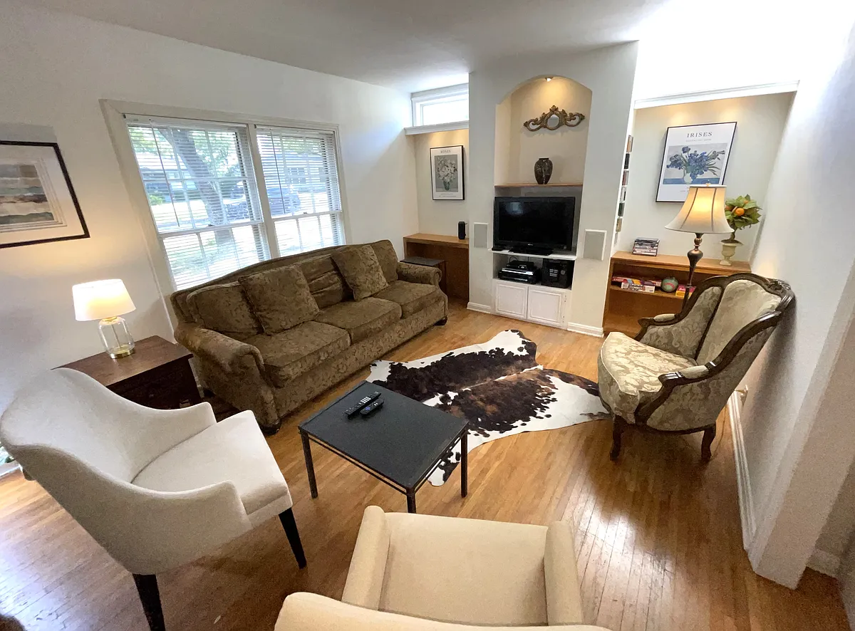 Stylish Living Room Features Wood Floors, LED TV with Roku For Streaming, Built-In Bookshelves and LED Lighting, Bluetooth Speaker. Sofa is a Queen Sleeper With Gel Memory Foam Mattress - 1914 W 38th St