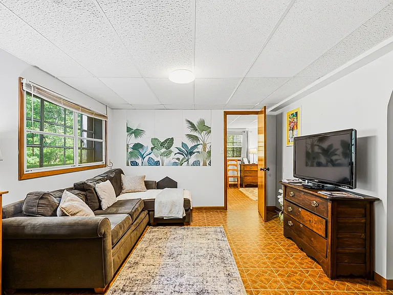 TERRACE LEVEL: Living Room and Entertainment. Door on left, Bathroom. on right, Bedroom ahead, and Kitchen/Laundry/Dining behind camera)
