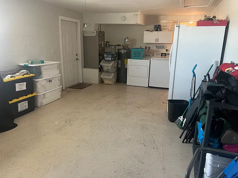 Garage with washer dryer and extra refrigerator for guests usage
