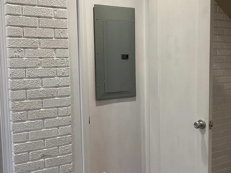 Electrical panel concealed in old doorway.