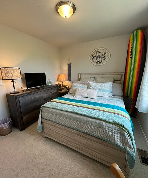 Bedroom 2 with queen bed and large window with views