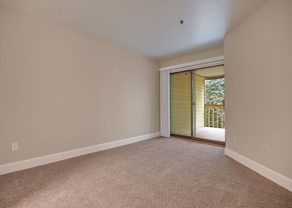 Large living area with sliding glass doors out to the balcony