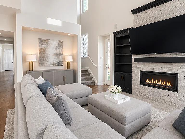 Open concept living room on main floor, upgraded fireplace and media wall with custom cabinets and shelving