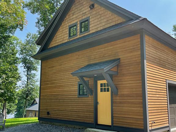 Entrance, garage, and a view of Little Bay (Great Bay) with owner's home in background