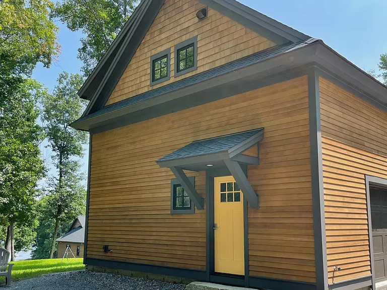Entrance, garage, and a view of Little Bay (Great Bay) with owner's home in background