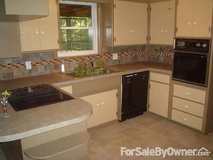 Updated Kitchen : New floor, countertop & backsplash with freshly painted walls & cupboards.