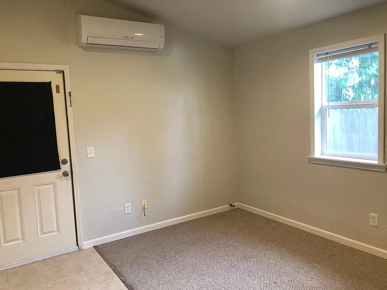 The mini split offers energy efficient heat and A/C. the back door leads out to a private patio area.