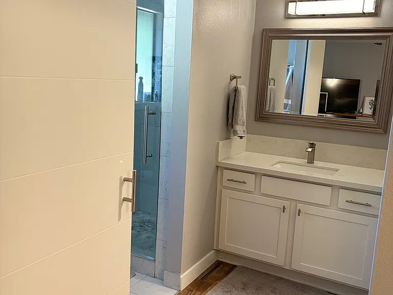 Shower and vanity in main bedroom.