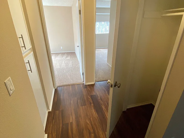 Hallway closet, linen closet and bedrooms view at Grande Vista Apartments.