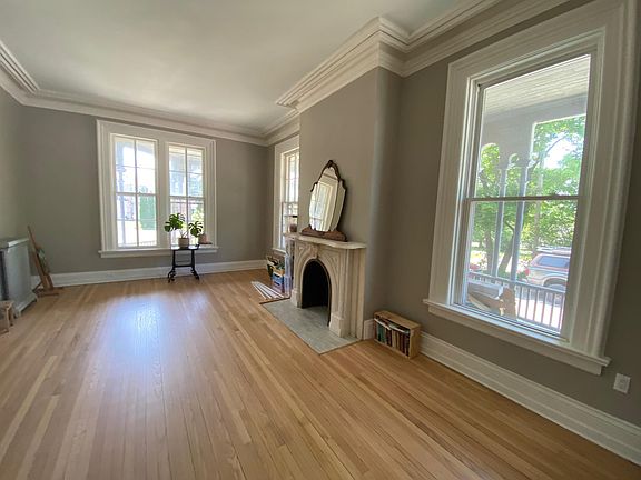 Living room, marble mantel, 11 foot ceilings, white oak floors, 75" long windows