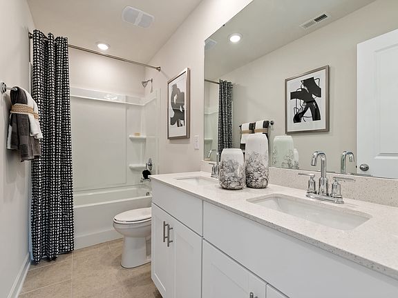 The secondary bath offers space for guests to get ready. Photography from Morgan Hills in Charl