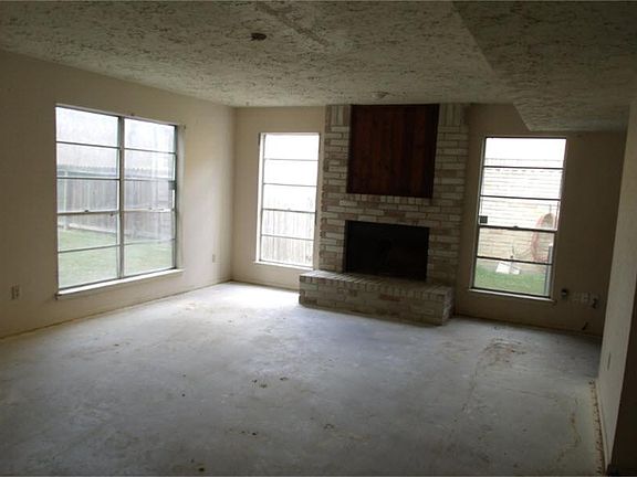 Den with fireplace open to kitchen