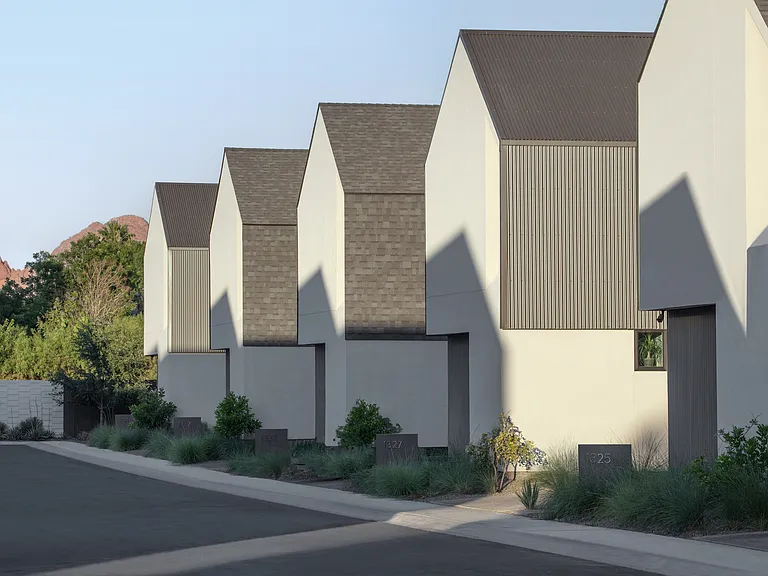 A thoughtfully composed modern community with sculptural rooflines, private residences, and views toward Camelback Mountain.