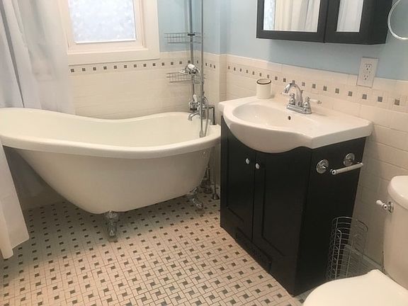 PICTURESQUE BATH This ML Bath offers a Claw Foot Tub with Freestanding mount Faucet, Mosaic Decorative Tile Floor and Original Built in Storage