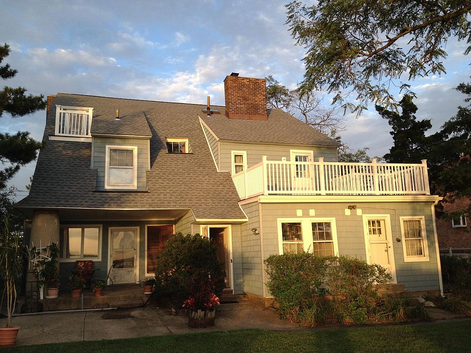 back of house view...3rd floor apt. entrance (middle door), & balcony on left