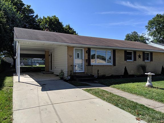 Carport and cement driveway.