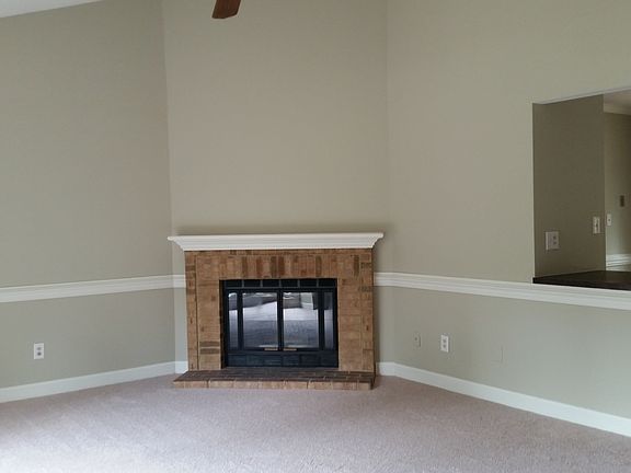 Living room with fireplace and ceiling fan