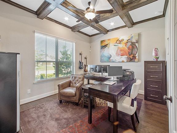 Study off entrance features french doors, wood floors and wood beam ceiling