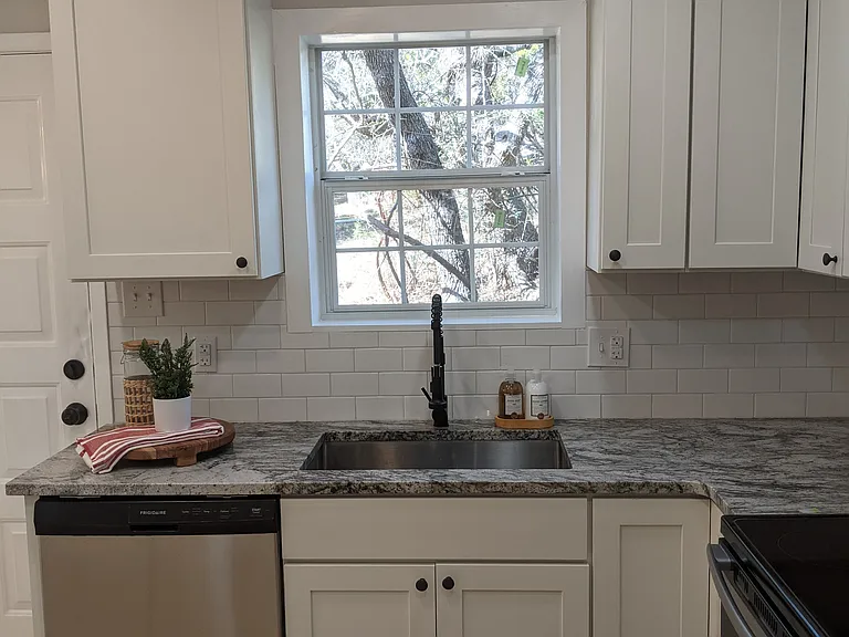 granite counters, stainless appliances, custom cabinets with soft close drawers and doors.