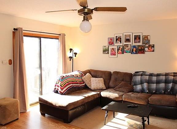 Bright living room with sliding glass doors to deck, half bath down hall