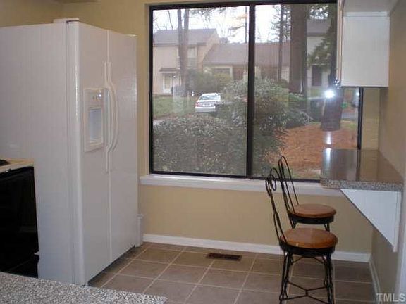 Kitchen with fridge & breakfast bar