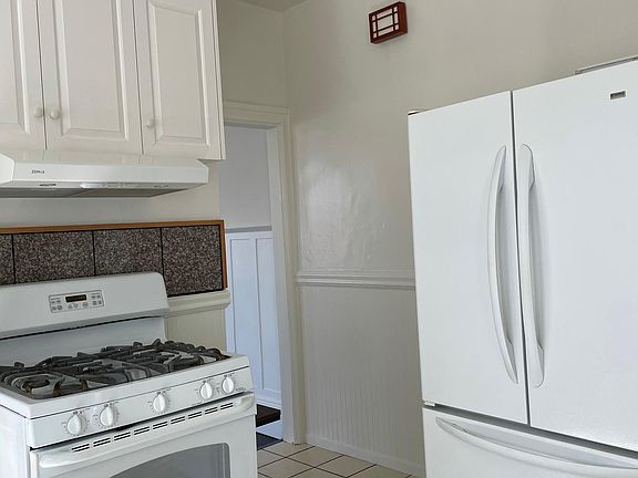 Kitchen with gas stove, refrigerator