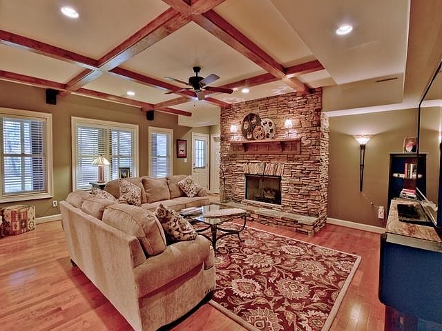 Fully furnished living room with 72-in TV.