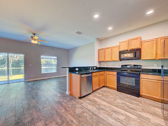 From hall to Kitchen and back yard view