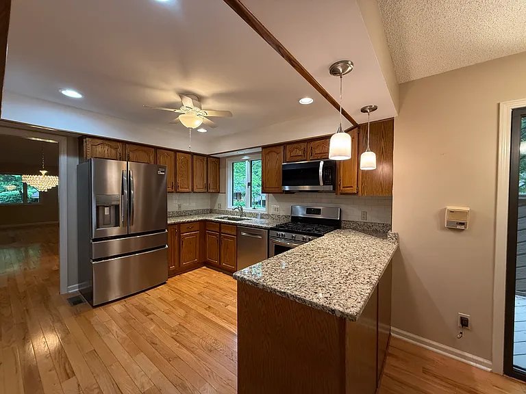 Well lit kitchen with new Frigidaire Gallery counter depth refrigerator.