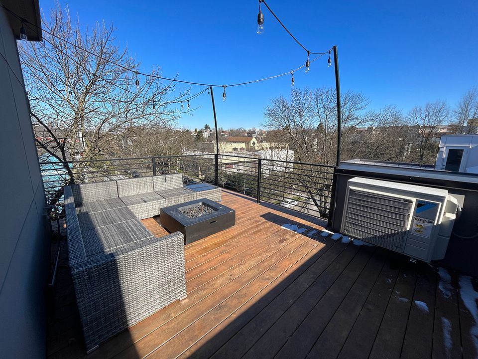 Private rooftop with included furnishings: couch (cushions kept inside during winter except when in use), edison lights, and fire pit with direct gas line to the house. Just turn on and light!