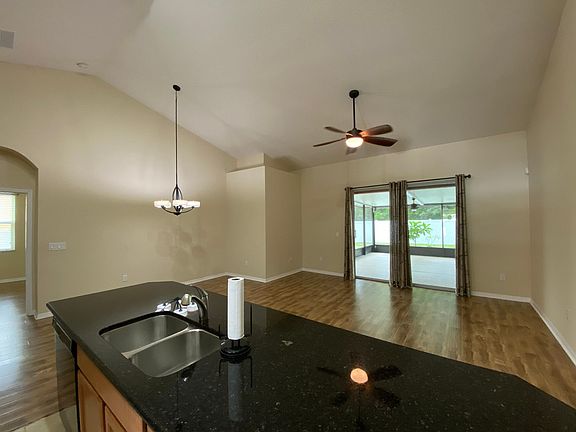 Living room open to kitchen and sliders to porch room
