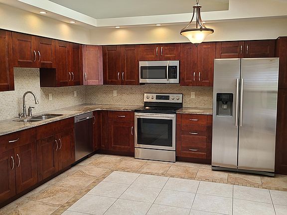 Matching appliances and granite counter tops, pantry to right of refrigerator