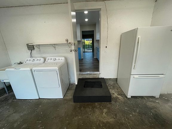 New washer/dryer and extra refrigerator in 2 car garage