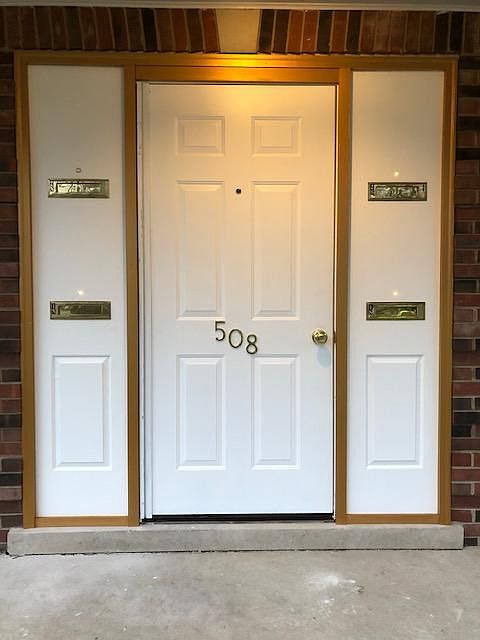 Front door of the building with mail slots for retrieving mail inside